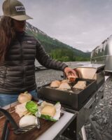 magma grill cooking food in the mountains